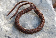 "8 BRAID LEATHER BRACELET - HANDMADE Made with eight leather strips, this braided \"wheel\" is full of difficulties and beauty. Leather bracelet with a round shape where all the threads intersect, this model is made without body. Without central part, only the strength of the fingers gives resistance to the bracelet. Impressive piece of craftsmanship for its work and its size. ✔ 100% Handmade ✔ Water resistant Bracelet diameter: 1.1 cm / 0.43 in. WRIST MEASUREMENT: To find out the size of your w Handmade Leather Braided Bracelet, Bohemian Braided Leather Bracelets, Bohemian Braided Leather Bracelet, Leather Bracelet For Men, Handmade Leather Bracelets, Braided Leather Bracelet, Bracelet For Men, Braided Bracelets, Bracelet Handmade