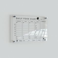 a daily food diary hanging on the wall