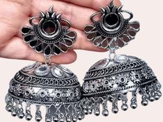 --------Welcome to Adornn Jewels--------- Traditional Oxidized Black Silver Afghani Style Big Mirror Hanging Jhumki Earrings Black Silver Hanging Earrings with Jhumki. The earrings are made of oxidized silver and are big in size. They are set with large oxidized silver mirror hangers and have a big black stone in the middle.Earrings that give you a fashion-forward look. These beautiful mirror-like earrings are oxidized black in color with a silver base and have a bold, silver border around the f Big Oxidised Jhumka, Elegant Oxidized Finish Dangle Jhumkas, Festive Oxidized Jhumkas For Rituals, Festive Oxidized Jhumkas Drop Earrings, Festive Oxidized Metal Jhumkas, Mirror Hangers, Jhumki Earrings, Jewelry Cleaning Solution, Beautiful Mirrors