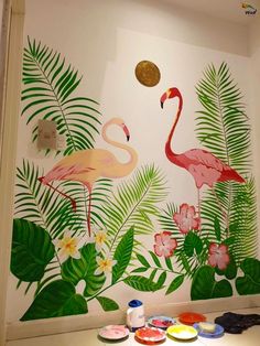 the wall is decorated with flamingos and tropical leaves