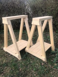 two wooden benches sitting in the grass