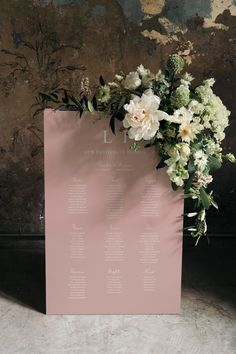 a wedding seating chart with flowers on it