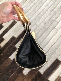 "When vintage looks this modern, it's a great thing. This black and gold evening bag/tiny tote is tres chic. So good with just about anything. Small but interestingly, roomy enough to hold a whole bunch cos of the wide roundish base. Measures 5-1/4\" (width) x 6\" (height excluding handles) x 5\" (base width) Condition: Excellent. Minor wear on gold rings. This bag is clean and ready to use. Comes from a smoke and pet free home. Don't forget to follow me on Instagram @tammaraclearshercloset for Black And Gold Purse, Gold Evening Bag, Gold Purse, Peacock Dress, Gown Photos, Tres Chic, Seafoam Green, New Vintage, Black And Gold