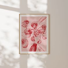 a red and white drawing hanging on the wall next to a window with sunlight streaming through it