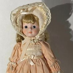 an old doll is wearing a bonnet and dress