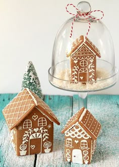 two small gingerbread houses under a glass dome