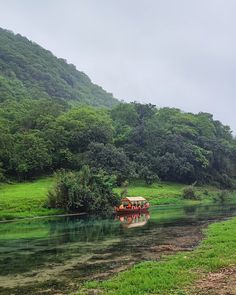 a group of people riding on the back of a boat in a body of water