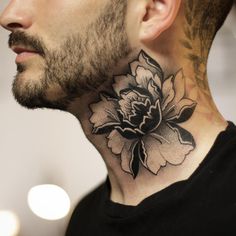 a man with a flower tattoo on his neck