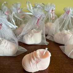 several pairs of baby shoes wrapped in organ bags