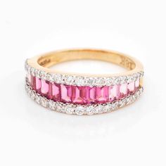 Step into a world of timeless beauty and sophisticated allure with our exquisite 18-karat gold Pink Tourmaline Baguette Diamond Contemporary Wedding Band Ring. This enchanting piece is a true masterpiece, expertly designed to capture the essence of art, color, and culture in a seamless blend of elegance and contemporary charm.