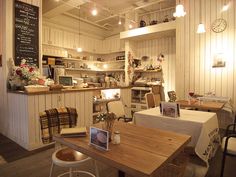 a restaurant with wooden tables and white walls