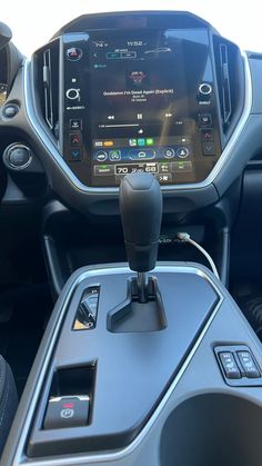 the inside of a vehicle with an electronic device in it's center console and dashboard