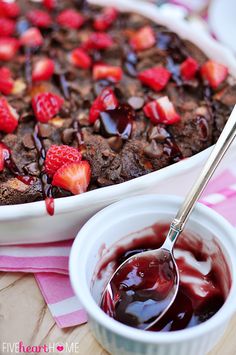 a close up of a plate of food with fruit on it and a bowl of chocolate pudding