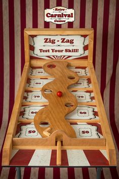 an old fashioned wooden game with red balls and numbers on the board in front of a striped background