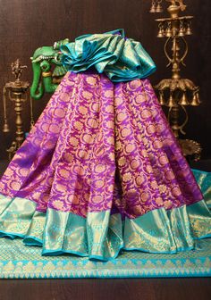 This purple Kanjivaram pure silk saree is a masterpiece of traditional craftsmanship and opulent design. The rich purple hue exudes regal elegance, while the exquisite floral zari brocade adds a layer of intricate, shimmering detail that enhances the saree's luxurious appeal. The saree is framed by striking blue contrast borders, which provide a vibrant and complementary touch to the overall design. The combination of the deep purple, intricate zari work, and bold blue borders makes this saree a stunning choice for grand occasions, ensuring you make a memorable and sophisticated statement. SILK MARK CERTIFIED This saree is ready to wear with fall and pico done. Handmade silk tassels adorn the pallu and add more grace to it. An unstitched blouse fabric is included. *Note: There may be minor Luxury Purple Brocade Saree, Luxury Purple Dola Silk Traditional Wear, Luxury Silk Fabric With Zari Work, Regal Elegance, Silk Tassels, Saree Blouses, Pure Silk Saree, Rich Purple, Zari Work