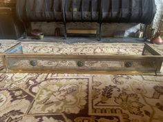 a metal fireplace grate sitting on top of a carpeted floor next to a fire place