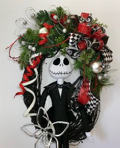 a halloween wreath with a skeleton wearing a suit and bow tie, decorated with christmas decorations