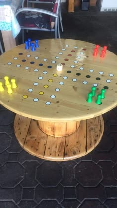 a wooden board game table sitting on top of a patio