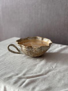 a bowl sitting on top of a white table cloth