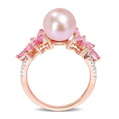 Bursting with sweet color and floral charm, this pink freshwater cultured pearl, pink sapphire and diamond ring is destined to delight. Fashioned in 14K rose gold This look features a lustrous 9.0-9.5mm round pink freshwater cultured pearl. Flanking the center, vibrant flower designs glisten with multi-sized marquise-cut and round bright pink sapphires. The diamond-touched split shank adds a touch of sparkle. This ring shines with 1/8 ct. t..w of diamonds. Fancy Pink Diamond Ring, Pink Diamond Ring, Jared The Galleria Of Jewelry, Pink Sapphire Ring, Pearl Pink, Peoples Jewellers, Floral Ring, Diamond Flower, Sapphire Stone