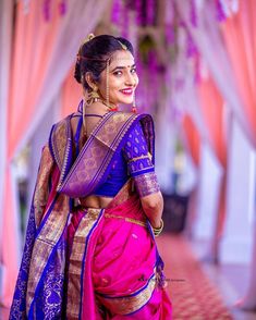 a woman in a pink and blue sari