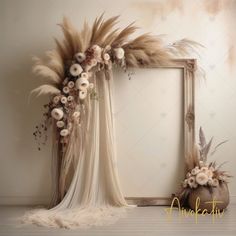 a photo frame with flowers and feathers on the floor in front of a white wall