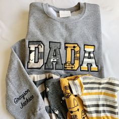 How to order: 1. Select sweatshirt SIZE and COLOR  2. Select NAME ADD ON 3. In the personalization box please include:  🧵 Text for chest (3-5 letters - MAMA, DAD, DADA, PAPA, GIGI, NANA, etc..) 🧵 Name of child(ren) if needed 🧵 Thread color  (thread color is used for both text across chest and text on sleeve, unless otherwise indicated)  4. ADD TO CART 5. I will message you on how and where to send your baby/ child clothes 🔁 Repeat these steps if purchasing an additional sweatshirt for dad or Dad Sweaters, Baby Clothes Gift, Child Clothes, Sewing Gifts, Baby Outfits, Grandpa Gifts, Mom Outfits, Color 2, Clothes Gift