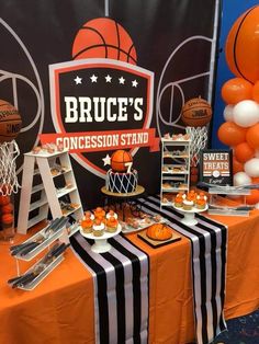 an orange and black basketball themed dessert table