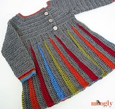 a crocheted dress with buttons on the front and side, in different colors