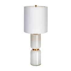 a table lamp with a white shade on the top and gold trim around the base