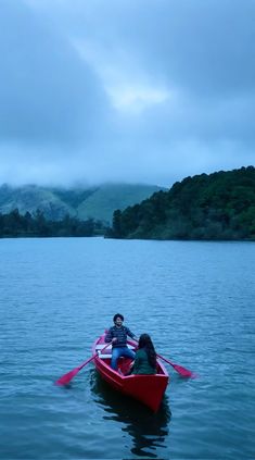 two people in a red boat on the water