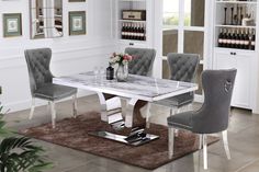 a dining room table and chairs with marble top