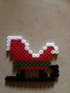 a piece of lego art made to look like a santa clause or sleigh