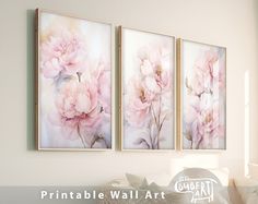 three pink flowers are hanging on the wall