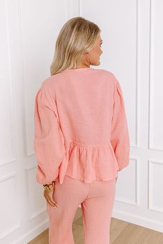 - Stay dressed to chill in this trendy top! Featuring soft material designed for comfort and style, this piece is perfect for lounging, exploring a vacay villa, or simply soaking up the good vibes. - Unlined subtly textured material - A v-cut neckline with a tie detail - Long, loose sleeves with elastic cuffs - A relaxed silhouette that ends in a peplum hemline Measurements S : Bust 40", Hip 46", Length 22", Sleeve Length 21", Waist 36". M : Bust 42", Hip 48", Length 23", Sleeve Length 22", Wais Loose Sleeves, Trendy Top, Front Tie Top, Tie Top, V Cut, V Cuts, Trendy Tops, Material Design, Soft Material