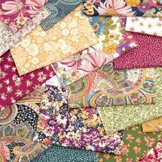 an assortment of colorful fabrics and fabric swatches in different colors, patterns and sizes