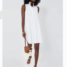 The Sleeveless Charlie Dress Is A Customer Favorite And Refreshed For Warm-Weather. This Classic White Mini Will Take You From Day To Night With The Quick Switch Of Shoes. We Love Pairing This With A Denim Jacket And Sneakers For A Sporty Look Or Espadrilles And Statement Earrings For Dinner Al Fresco! Stand Collar Sleeveless Button Front Placket Side Seam Pockets Mini Length Full A-Line Silhouette Material: 58% Cotton, 40% Nylon, 2% Spandex Care: Dry Clean Only Xxs Pit To Pit 18” Xs Pit To Pit White Sleeveless Day Dress, White Sleeveless Daywear Dress, White Sleeveless Maxi Dress For Daywear, White Sleeveless Dress For Daywear, White Sleeveless Shirt Dress For Daywear, Chic Sleeveless Shirt Dress For Daywear, Elegant White Sleeveless Dress For Daywear, Sleeveless Shirt Dress For Summer Daywear, White Sleeveless Shirt Dress For Work