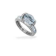 an oval aqua blue topazte and diamond engagement ring with matching band, set in 18k white gold