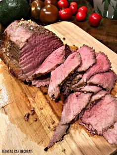 sliced meat sitting on top of a wooden cutting board