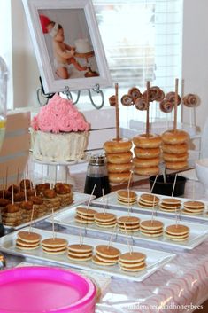 a table topped with lots of donuts and cupcakes