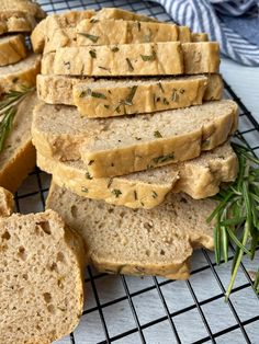 slices of bread on a cooling rack with rosemary sprigs