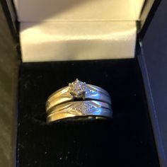 two gold wedding rings sitting in a box