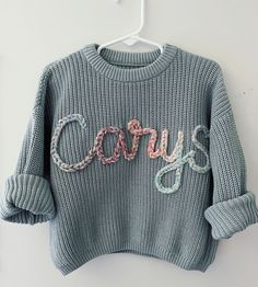 100% cotton oversized chunky knitted sweaters! perfect for birth announcements, newborn/family photos, baby shower gifts, birthday gifts! Each name is hand embroidered and made to order, therefore no two will look the exact same. *Please note that 0-3 is not available in Cream, Navy or Spruce(darker green available In that size if interested)* Yarn: extra chunky- best for 5 letters or less on smaller sweaters. If you're unsure about yarn type and length of name reach out to me for recommendation Cute Cotton Chunky Knit Sweater, Cute Cotton Crochet Sweater, Cute Crochet Cotton Sweater, Chunky Knitted Sweaters, Baby Name Sweater, Family Photos Baby, Name Sweater, Baby Boy Sweater, Newborn Family Photos