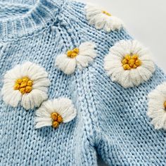 a blue sweater with white flowers on it