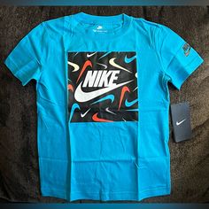 Nike Kids' Print Hook Graphic Tee In Chlorine Blue Size M 5-6 Yrs. Sports Shirt With Blue Logo Print, Blue Sports Shirt With Graphic Print, Blue Graphic Print Sports Shirt, Blue Nike T-shirt With Logo Print, Nike Blue T-shirt With Logo Print, Blue Graphic Tee For Sports, Nike Blue Shirt With Graphic Print, Nike Blue Casual Shirt, Nike Casual Blue Shirt