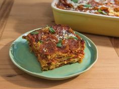 two plates with lasagna casserole on them, one is green and the other is blue