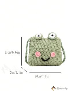 a green crocheted purse with eyes on the front and bottom, measurements for it