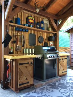 an outdoor kitchen with lots of cooking utensils