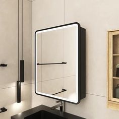 a bathroom with a sink, mirror and shelves on the wall next to each other