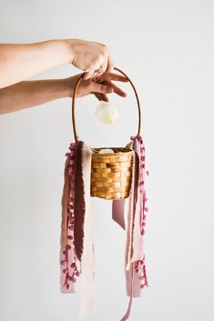 a person is holding a basket with something in it that has been made into a wind chime